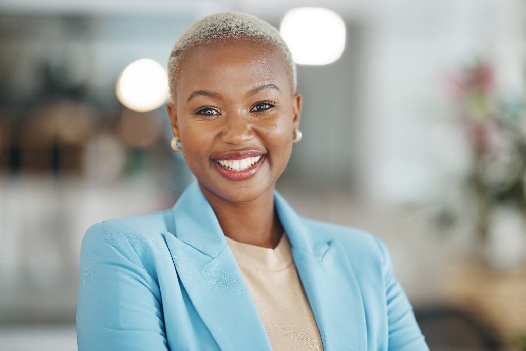 Professional headshot of a woman in a light blue blazer