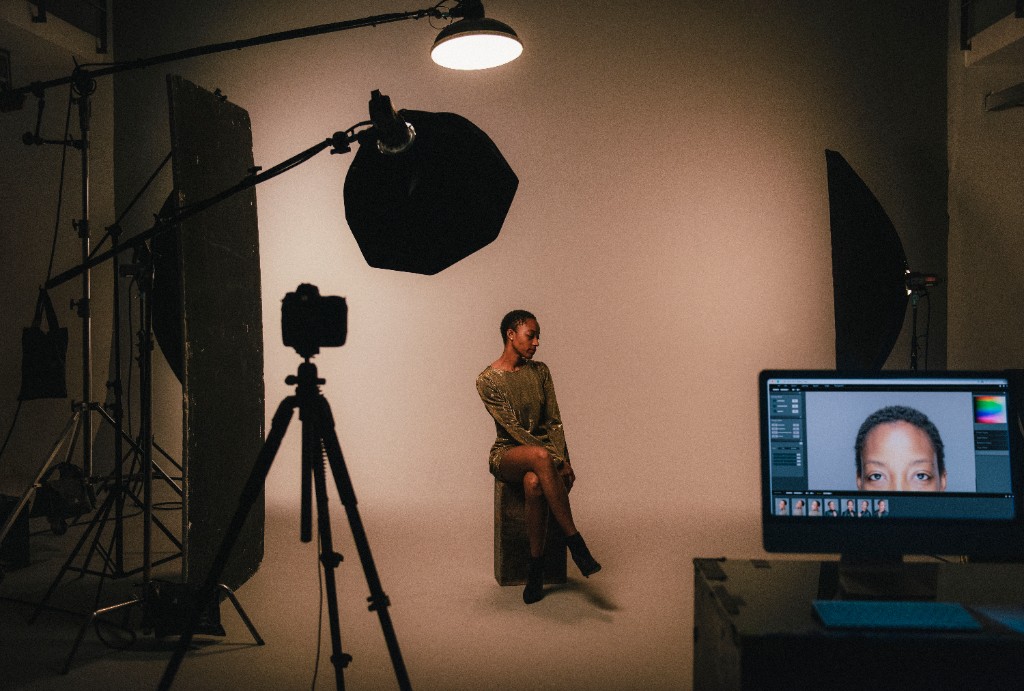 Studio portrait session with lights, a camera, and a backdrop